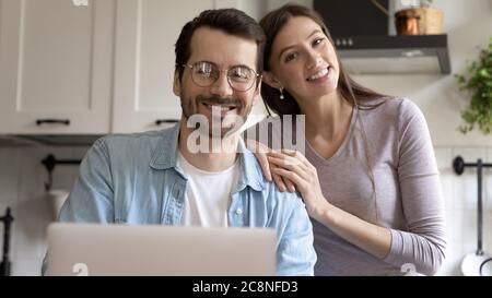 Portrait of happy young Caucasian couple posing at home Stock Photo