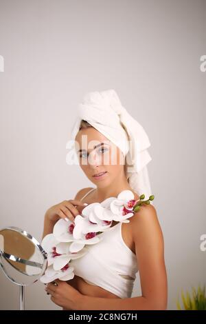 skin care and recovery.young girl with clean perfect skin. Blonde with natural touching her face. Spa Stock Photo