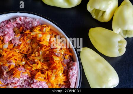 Bowl of raw minced meat and sauteed vegetables for stuffed bell peppers. Vegetables completely ready for filling with meat. Cooking dinner. Part from Stock Photo