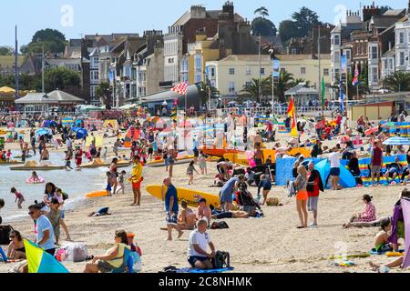 Weymouth, Dorset, UK.  26th July 2020.  UK Weather.   Sunbathers and holidaymakers flock to the beach at the seaside resort of Weymouth in Dorset on a morning of warm hazy sunshine.  Picture Credit: Graham Hunt/Alamy Live News