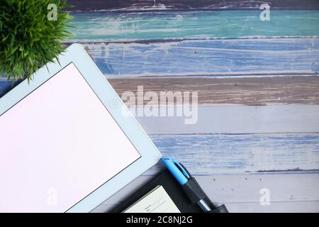 Flat composition of digital tablet and notepad on wooden background  Stock Photo