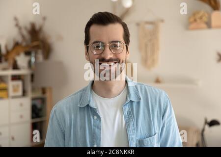 Profile picture of smiling millennial man in glasses posing Stock Photo