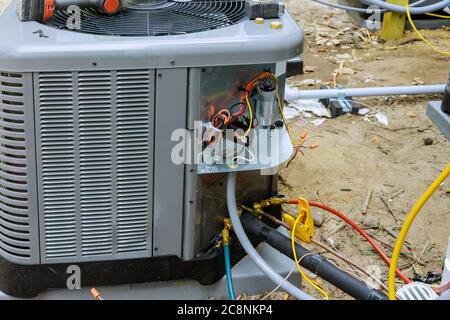 Air conditioning technician servicing of preparing to install new air conditioner Stock Photo