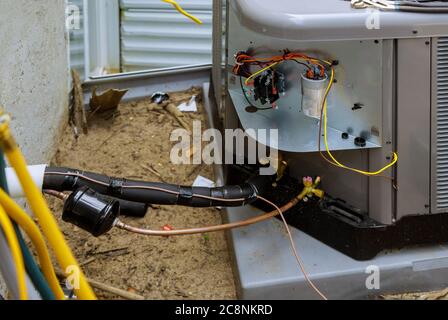 Installing the outdoor unit of the air conditioner in a client house Stock Photo