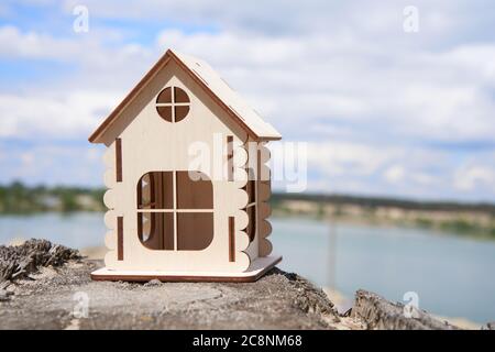 Miniature wooden house outdoor nature. Real estate concept. Modern housing. Eco-friendly energy efficient house. Buying home outside the city Fresh air. Mortgage, loan. Stock Photo