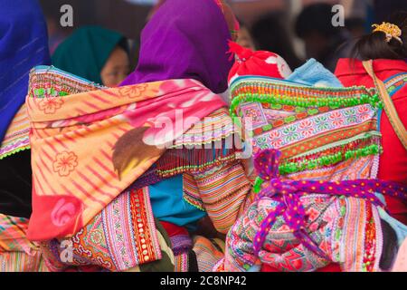 Bac Ha Market Vietnam 12/22/2013 Flower Hmong women carrying babies in shawl Stock Photo