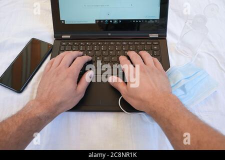 Man Typing On pc Keyboard while working on web business in coronavirus disease  Stock Photo