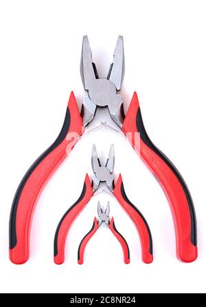 red and black pliers on white background, with different sizes and shadows. metal pliers with red and black plastic handles Stock Photo