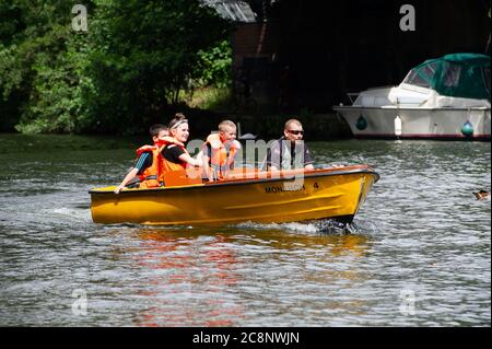 Windsor, Berkshire, UK. 26th July, 2020. Happy families out enjoying a trip down the River Thames in the warm morning sunshine in the shadow of Windsor Castle before torrential rain showers at lunchtime today. Credit: Maureen McLean/Alamy Live News Stock Photo