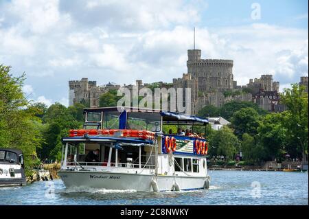 Windsor, Berkshire, UK. 26th July, 2020. Visitors to Windsor out on a guided river trip on a French Brothers passenger boat called Windsor Royal on the River Thames this morning in the warm morning sunshine before torrential rain showers at lunchtime today. Credit: Maureen McLean/Alamy Live News Stock Photo