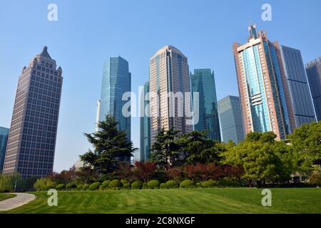 different colorful skyscrapers under blue sunny day in Lujiazui Park in Pudong of Shanghai Stock Photo