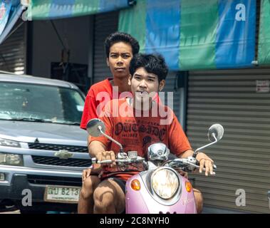 SAMUT PRAKAN, THAILAND, JUN 23 2020, Two boys ride on motorbike on a street. Stock Photo