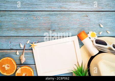 Beautiful summer holiday, Beach accessories, orange, sunglasses, hat and sunblock on wooden backgrounds Stock Photo