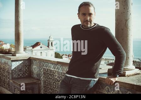 Portrait of a man leaning against a wall, Lisbon, Portugal Stock Photo