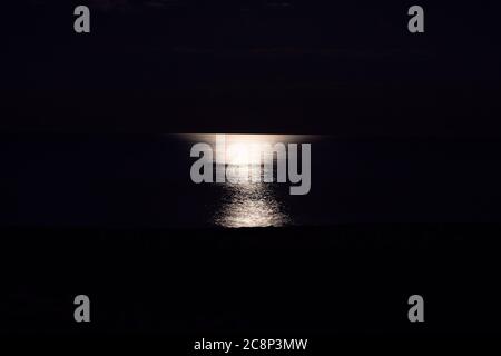 Moonlight reflection on the water . Sea surface in the night Stock Photo