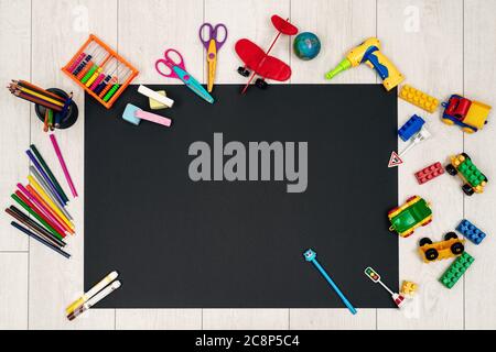 Set of different children's toys and stationery on a black background Stock Photo