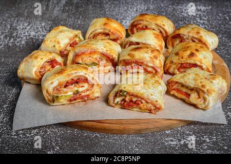 Mini pizza rolls on wooden board Stock Photo