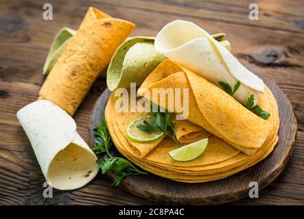 Different kinds of tortillas on the wooden table Stock Photo