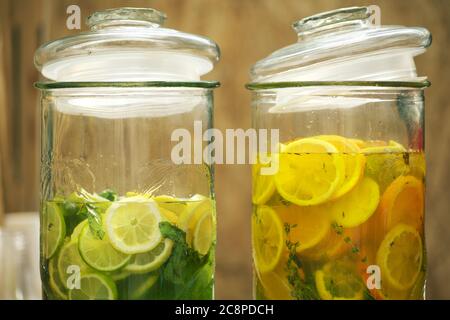 2 glass jars of lime and orange slices lemonade, cut into pieces Stock Photo
