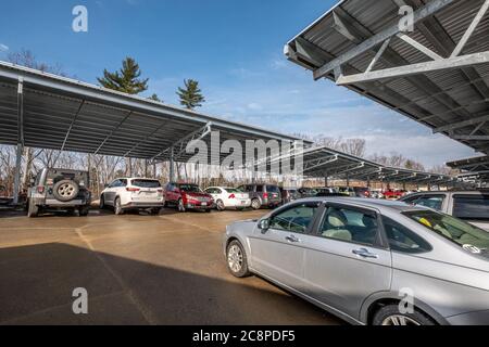 Solar panels installed at Heywood Hospital in Gardner, MA provide electricity for the hospital and cover for the cars in the parking lot. Stock Photo