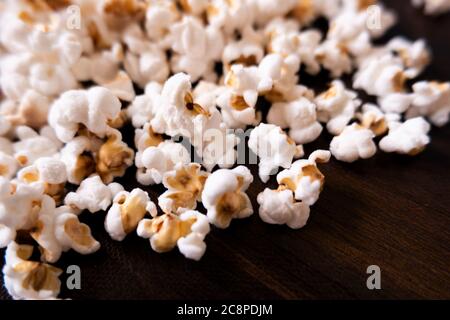 a closeup view of homemade Pop corns gathering on wooden table Stock Photo
