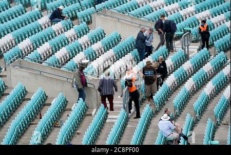 Spectators leave the Oval after the end of the day's play during the friendly match at the Kia Oval, London. Stock Photo