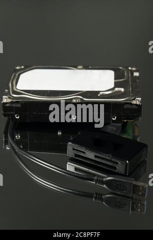 Universal card reader and hard drive isolated on black background Stock Photo