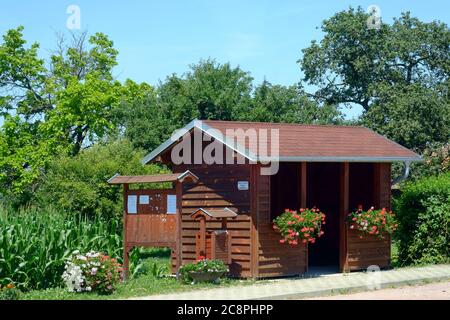 wooden bus shelter adorned with flowers in rural village zala county hungary Stock Photo