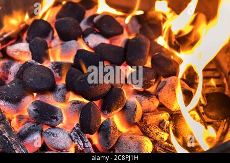 Top View Of Hot Flaming Charcoal Briquettes Glowing In The BBQ Grill Pit. Grill briquettes that are burning and waiting to be glowed for grilling Stock Photo Alamy