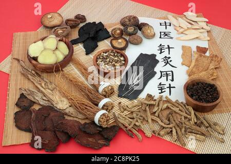 Chinese herb selection used as a tonic with acupuncture needles & script. Translation reads Acupuncture needles used in traditional Chinese medicine. Stock Photo