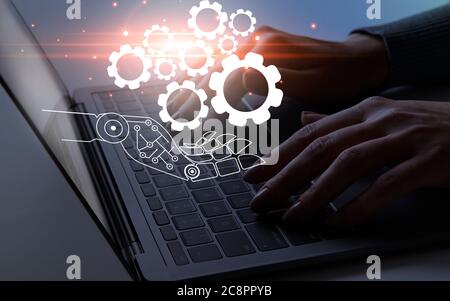 Connected gears on cyborg hand over working person Stock Photo
