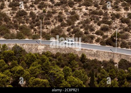 Car travelling along a windy road up a mountain Stock Photo