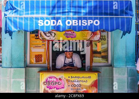 Havana / Cuba - 04.15.2015: A Cuban man selling ice cream in a shop, thinking deep thoughts Stock Photo