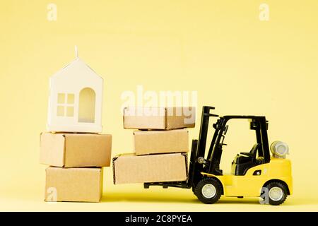 Mini forklift truck load cardboard boxes. Logistics and transportation management ideas and Industry business commercial concept. Stock Photo