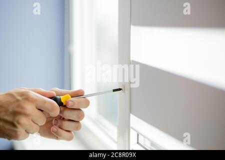 The man is repairing the plastic window Stock Photo