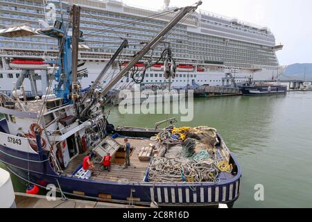 Ketchikan, Alaska - jul 23, 2018 - fishing boat on harbor with cruise liner docked in Ketchikan downtown Alaska. Stock Photo