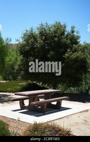 Brown picnic table in a public park Stock Photo