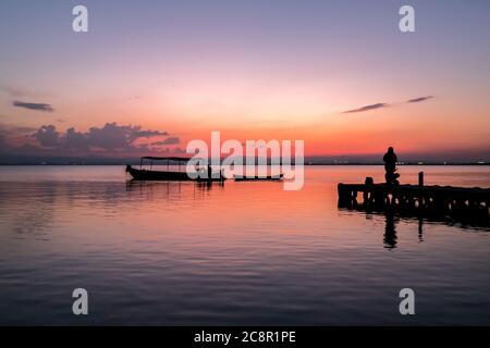 Sunset pier Albufera Valencia tourist ride boat reflections in the lake Natural Park Spain. Stock Photo