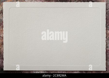 Light cream paper with an embossed patterned frame, an empty field for your design, colorful borders, backdrop. Copy space Stock Photo