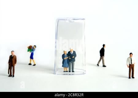 Pandemic corona virus conceptual miniature people photography – social distancing strategy - middle-aged figure on tube isolation. Image Photo
