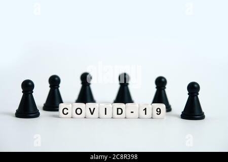 Pandemic coronavirus conceptual photography – stop spreading of COVID19 - word beads surrounded by chess pieces. Image Photo Stock Photo