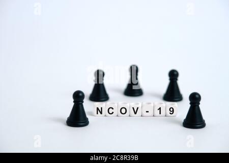 Pandemic coronavirus conceptual photography – stop spreading of COVID19 - word beads surrounded by chess pieces. Image Photo Stock Photo