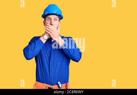 Young handsome man wearing worker uniform and hardhat feeling unwell and coughing as symptom for cold or bronchitis. health care concept. Stock Photo