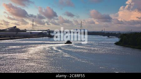Tugboat Down River at Dusk Stock Photo