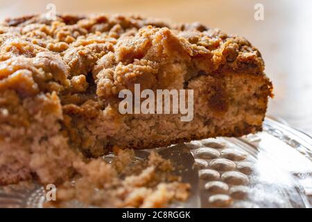 Close up of a cut coffee cake on a glass platter. Stock Photo