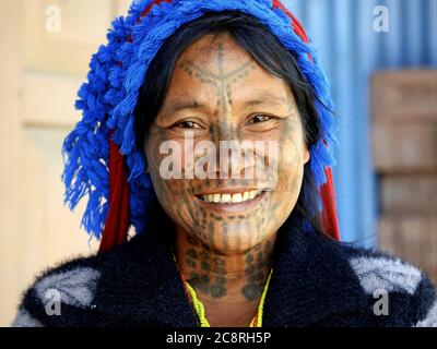 Middle-aged Chin Muun tribal woman ('spider woman') with traditional facial tattoo. Stock Photo