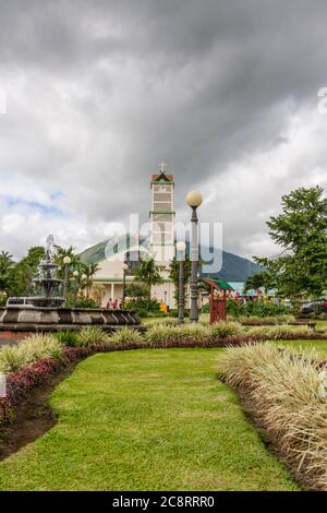 Catholic Church in La Fortuna, Costa Rica, with Arenal Volcano in the background. Arenal is an active volcano. Stock Photo