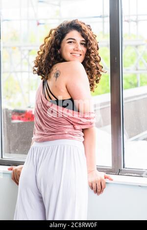 Fitness coach demonstrating stretches in studio Stock Photo