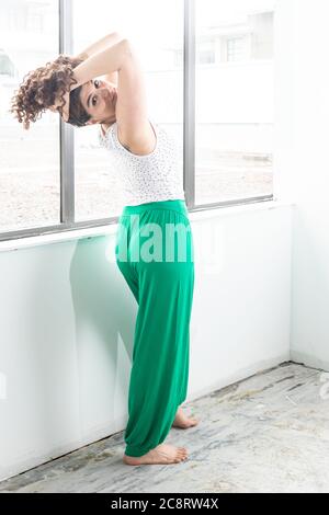 Fitness coach demonstrating stretches in studio Stock Photo