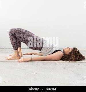 Fitness coach demonstrating stretches in studio Stock Photo